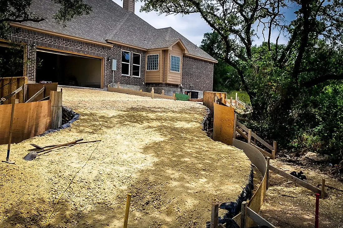 Compacted base and forms prepared for a concrete driveway in San Antonio