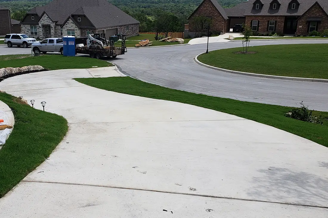 Concrete driveway meeting a cul-de-sac in a San Antonio neighborhood