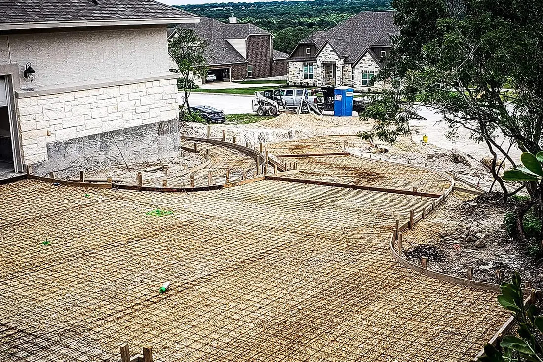Concrete driveway formwork and mesh on a hillside lot in San Antonio