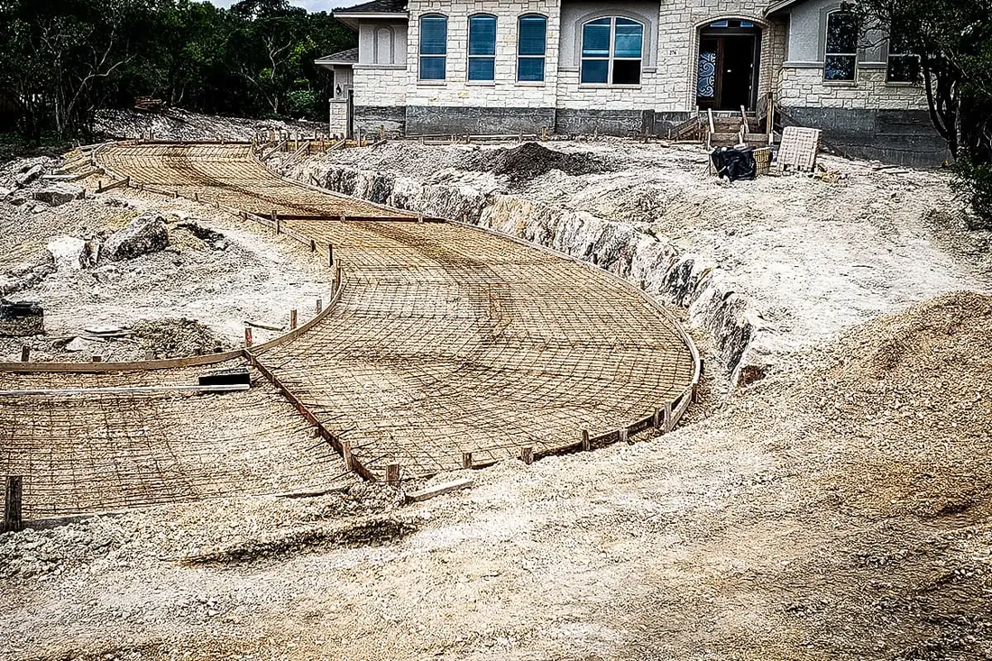 Rebar mesh tied out for a curved concrete driveway on limestone in San Antonio