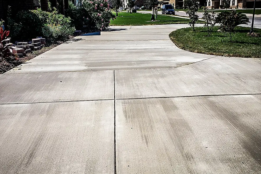 Jointed concrete driveway running to the street in a San Antonio subdivision