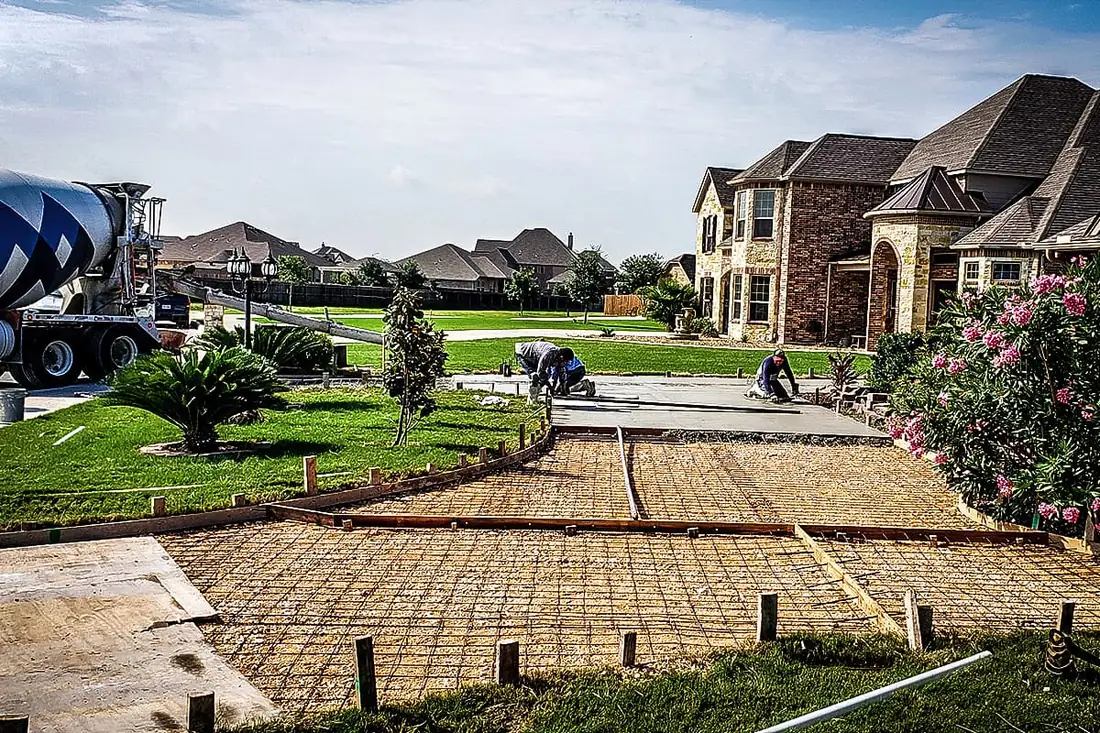 Concrete patio with decorative border in Bexar County
