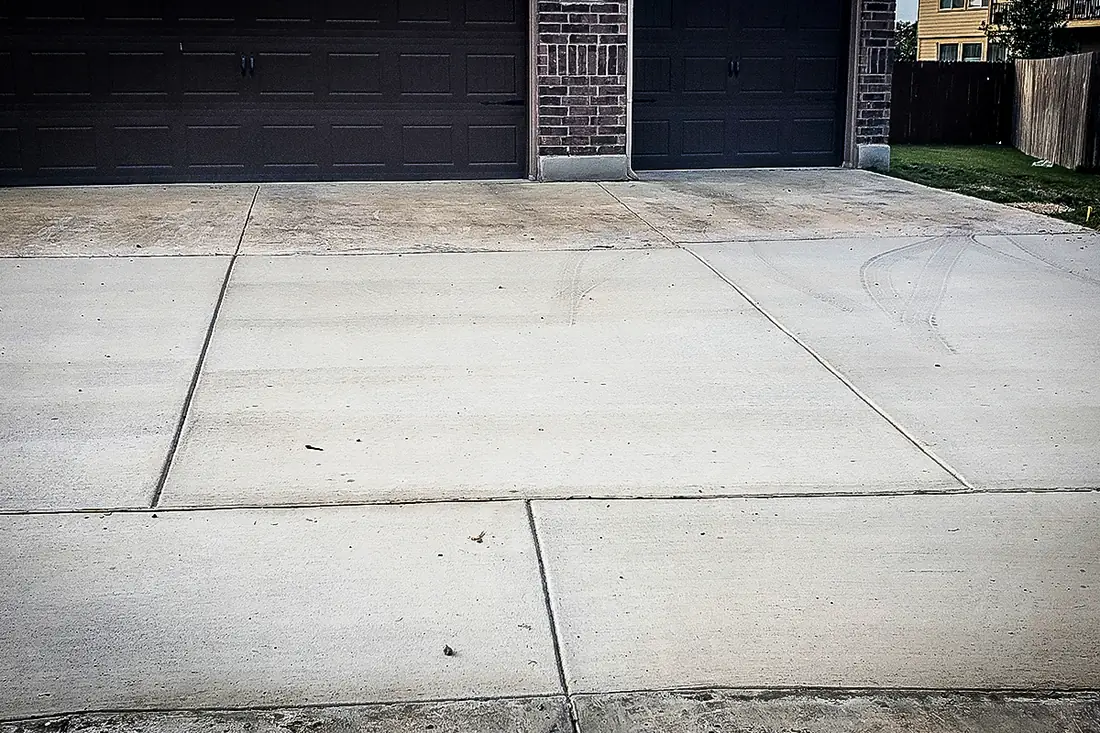 Concrete driveway and apron at a two-car garage in San Antonio